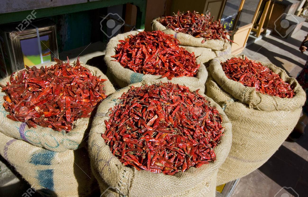 Baskets of dried red chilies and local spices in Jaipur bazaar