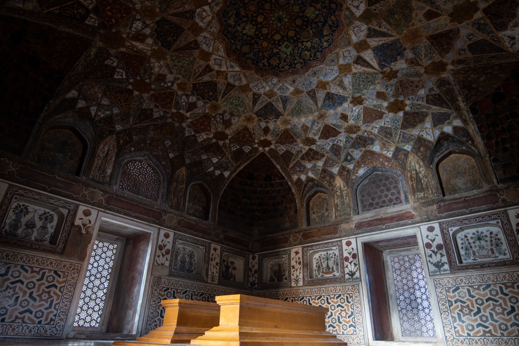 The painted vault and inlaid walls above the cenotaphs inside Itimad-ud-Daulah's tomb, Agra