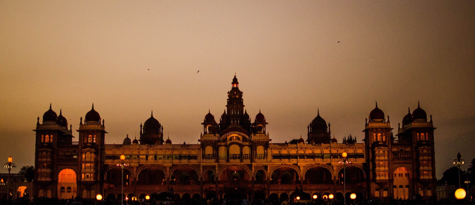 Mysore Palace under its illumination at dusk