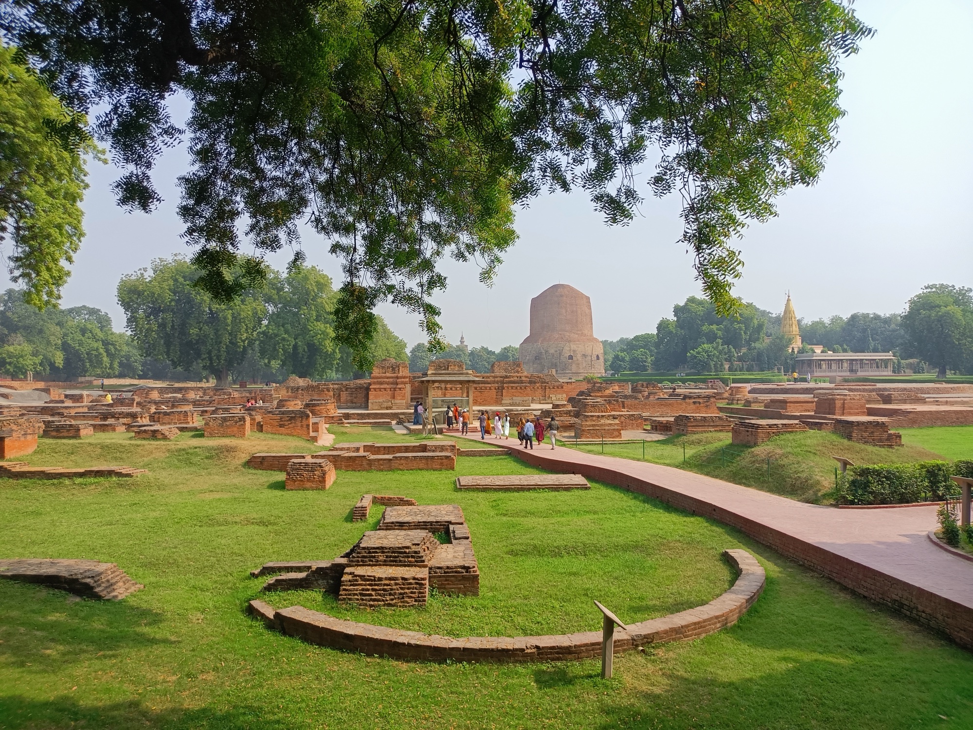 The Dhamekh Stupa rising above the excavated monastery ruins at Sarnath
