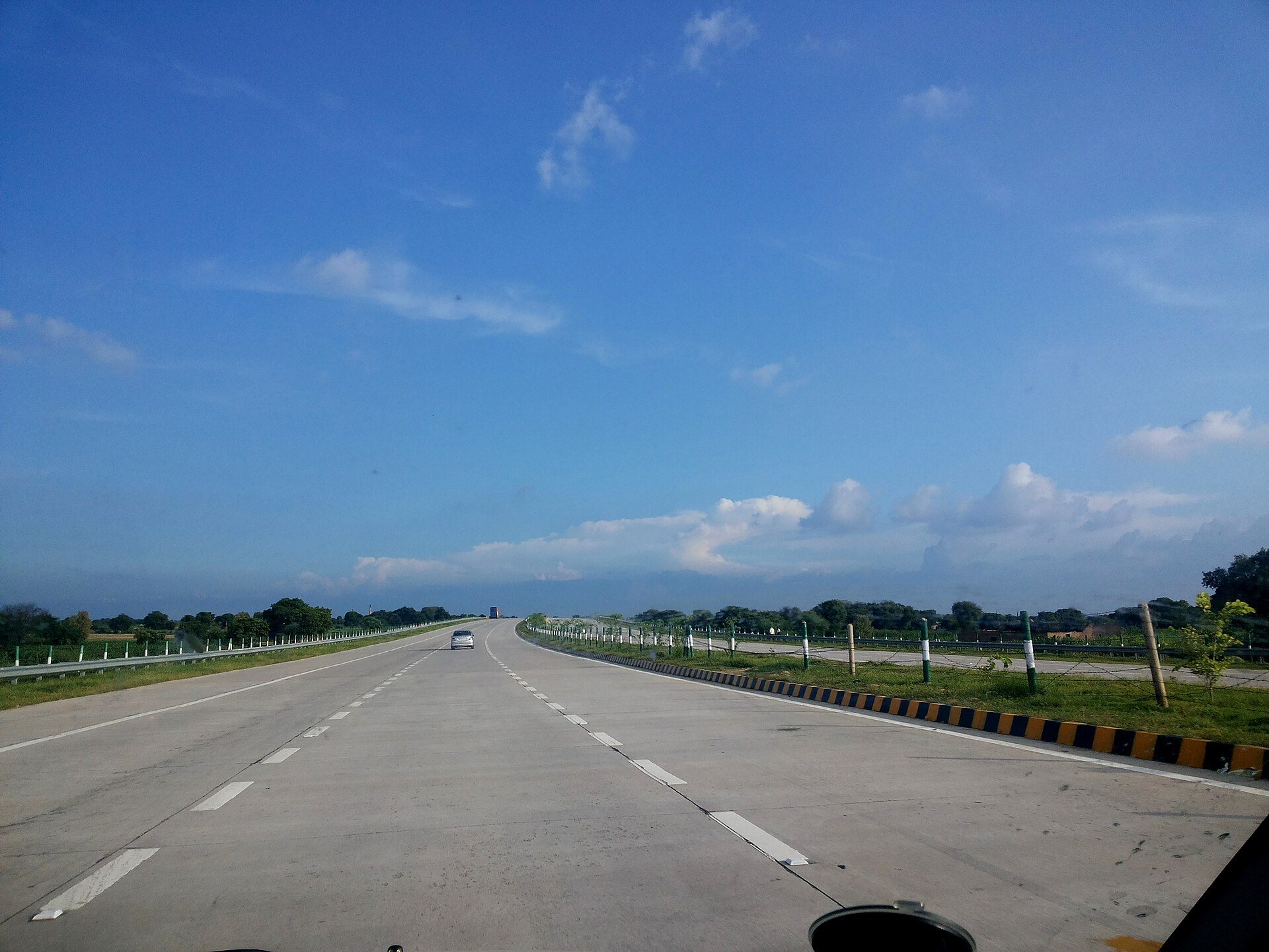 The Yamuna Expressway running south towards Agra, empty under a clear sky