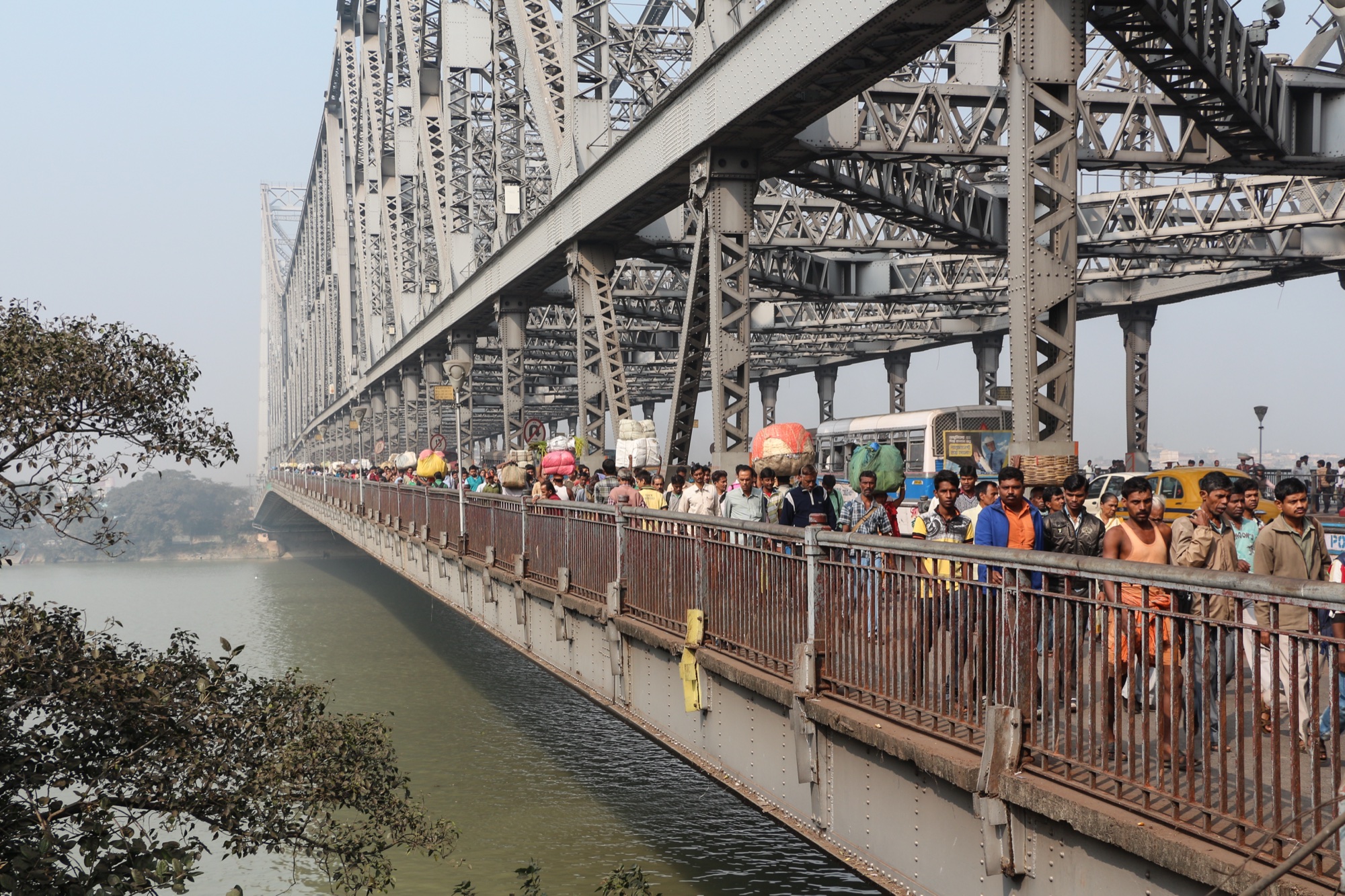 Commuters crossing the Howrah Bridge above the Hooghly, Kolkata