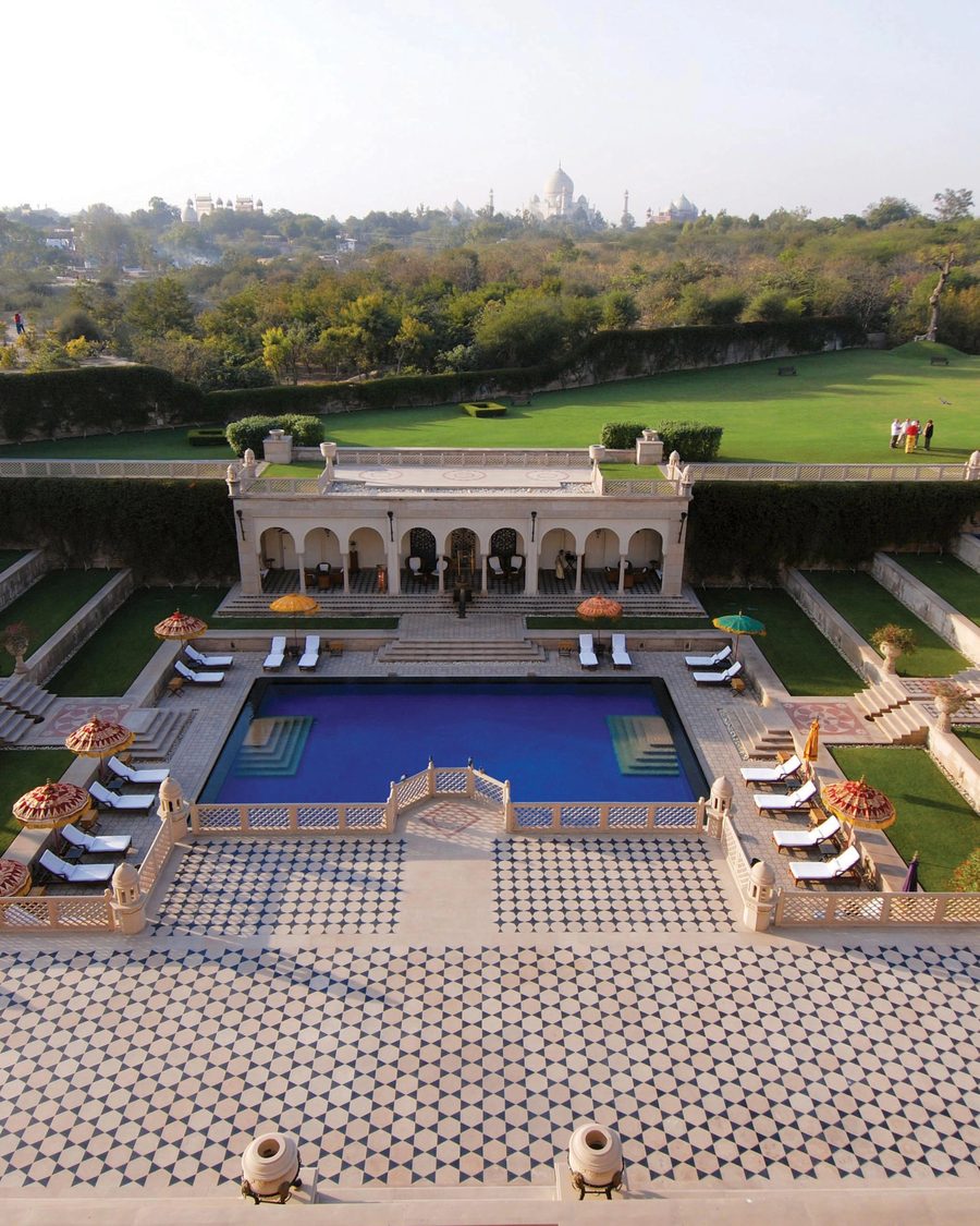 A formal Mughal garden descending to a reflecting pool with the Taj Mahal on the horizon, Agra