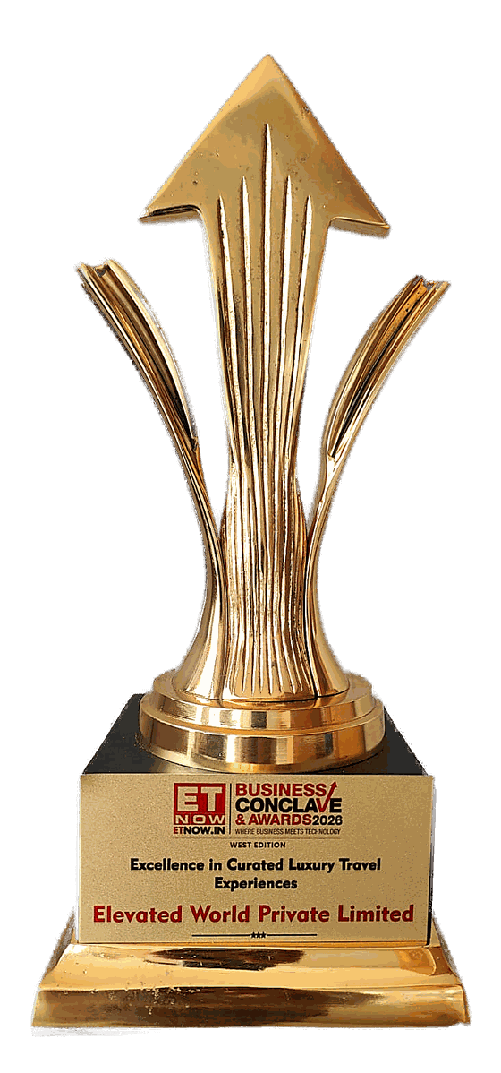 The ETNOW.in Business Conclave & Awards 2026 trophy, its plaque reading Excellence in Curated Luxury Travel Experiences, Elevated World Private Limited