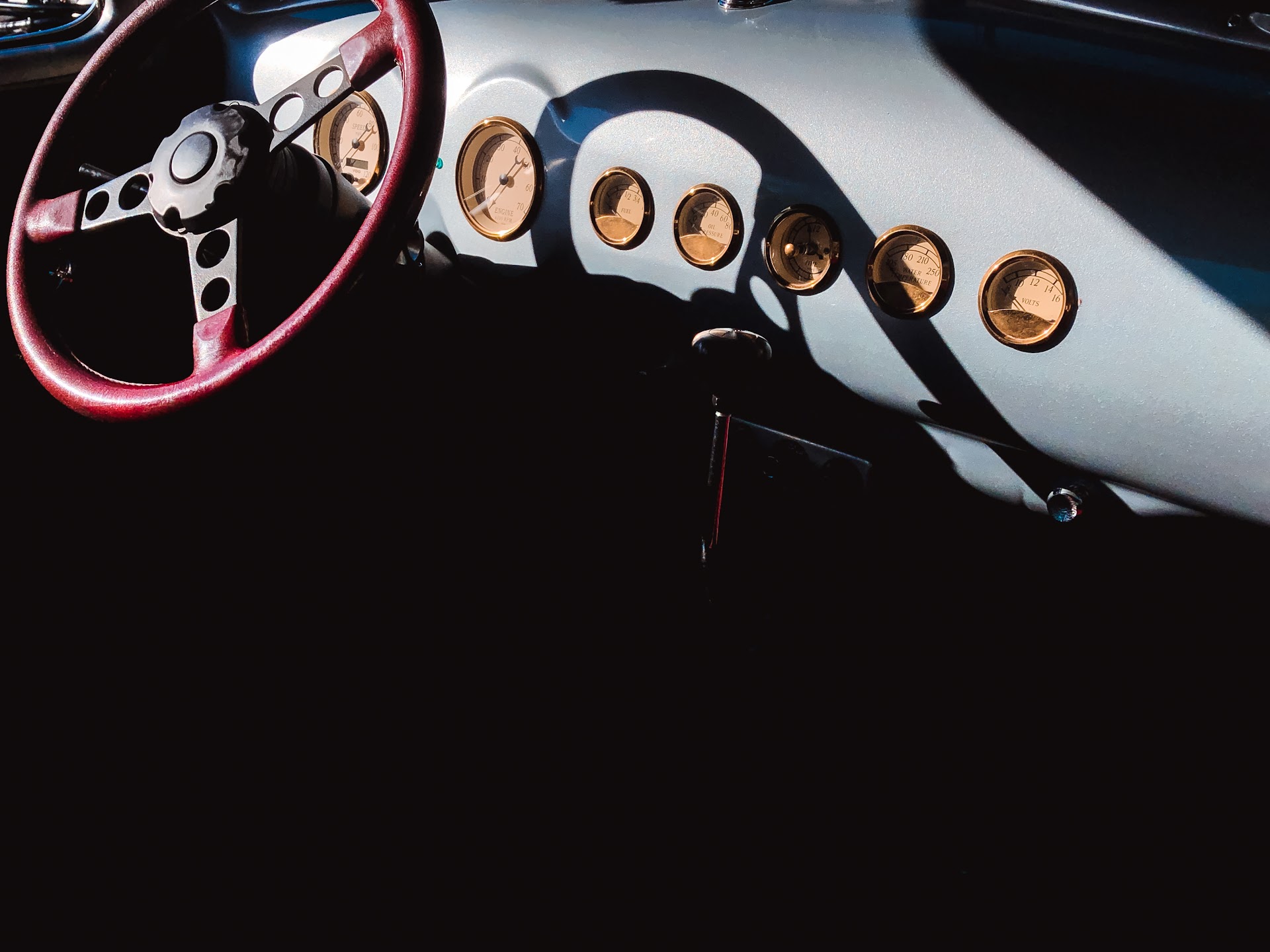 The leather and wood interior of a classic touring car