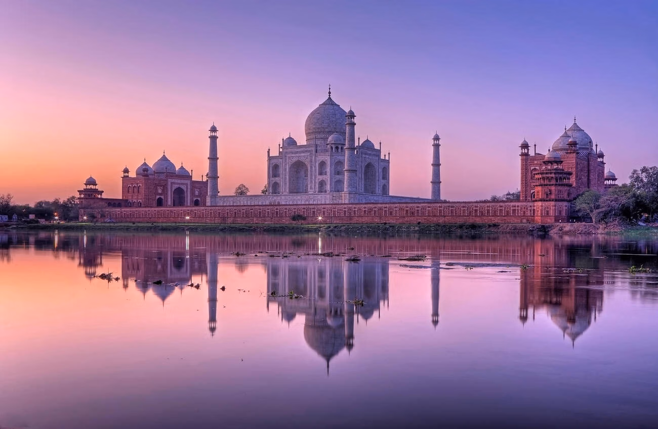 The Taj Mahal reflecting on the Yamuna river at sunset